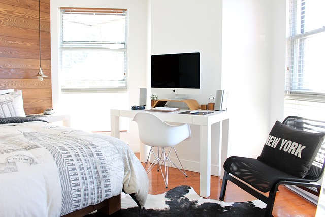 minimalist workspace nook with wall-mounted shelf and focused task lighting
